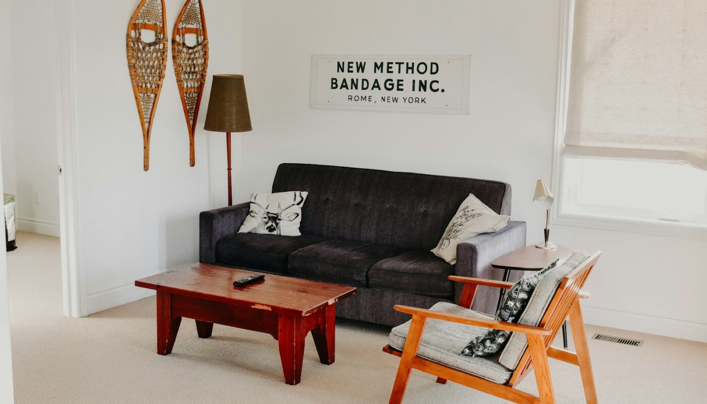 rectangular brown wooden coffee table near black 3-seat sofa