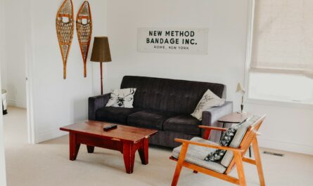 rectangular brown wooden coffee table near black 3-seat sofa